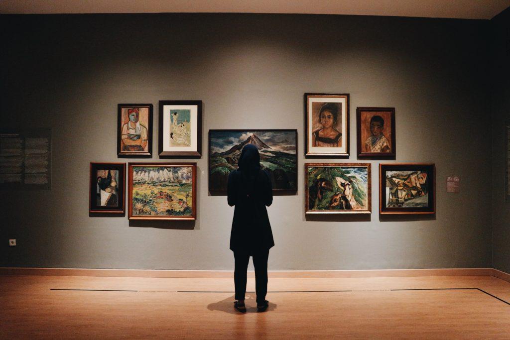 Woman looking at trending artwork in a gallery