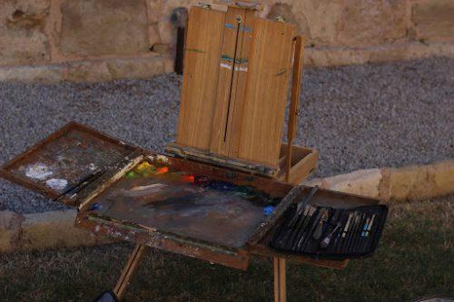 wooden box easel with a set of paint brushes